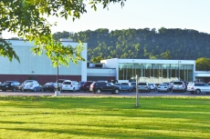 Vehicles arrive in the staff parking lot at Bluff View Elementary School. Behind them are the new gymnasium and cafeteria at the school. The school year begins Tuesday, Sept. 3.